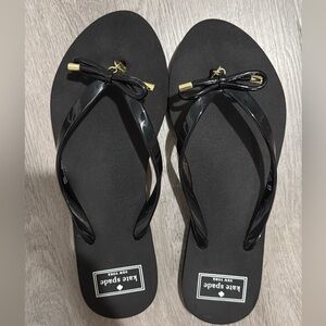 kate spade Black Patent Bow Flip Flop Sandals with Gold Accents